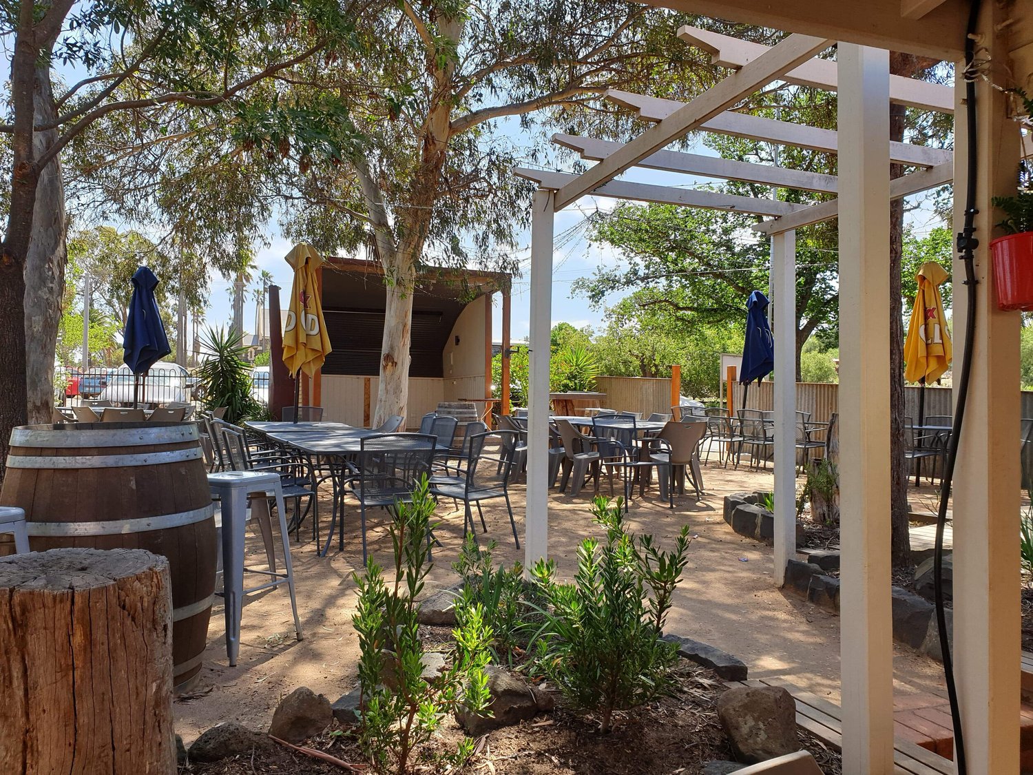 Tables set under the gums in the Axedale Tavern beer garden